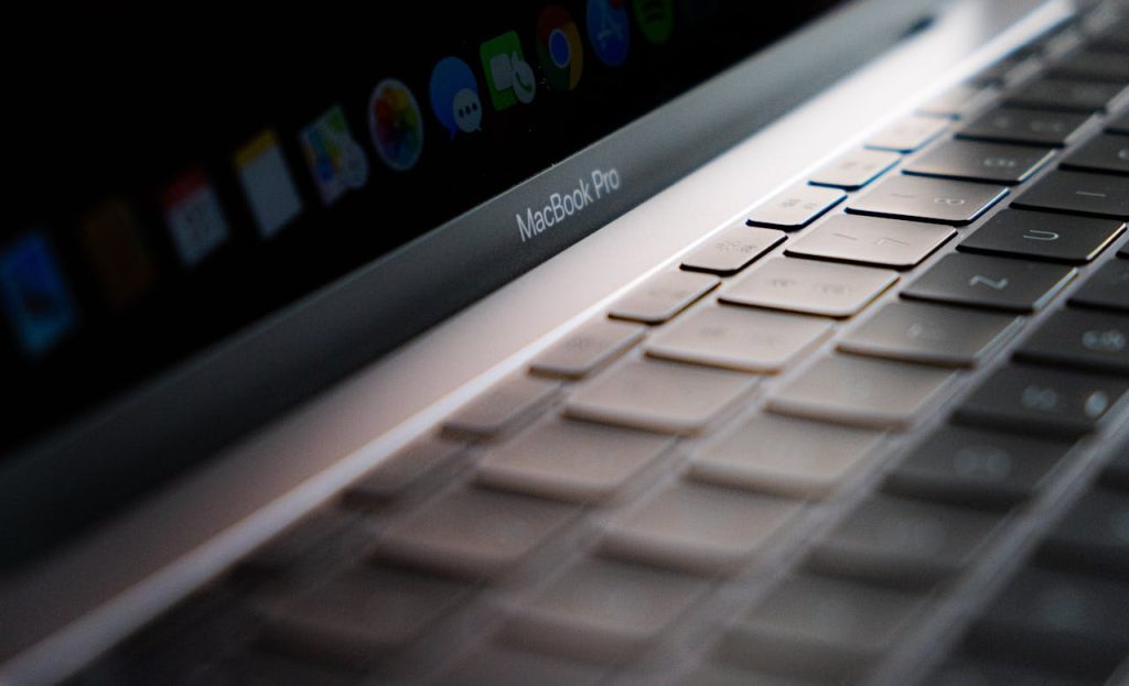Detailed close-up of a MacBook Pro keyboard showing the keys and backlight.